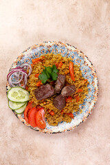 Traditional dish pilaf. On a brown background.