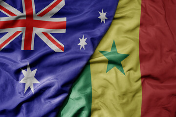 big waving realistic national colorful flag of australia and national flag of senegal .