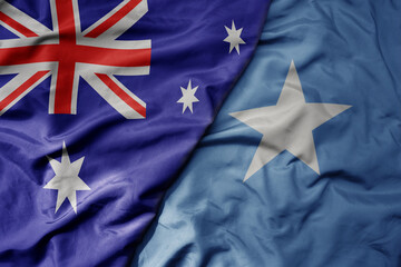 big waving realistic national colorful flag of australia and national flag of somalia .