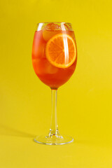 Orange cocktail. Aperol syringe. On a yellow background.