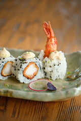 Sushi rolls with shrimp on ceramic plate