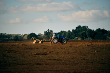 Fototapeta premium Tractor on field in countryside