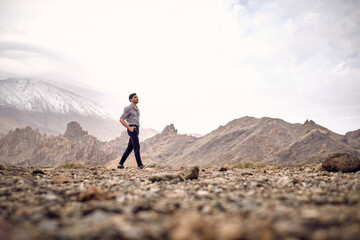 Hispanic man walking in mountains