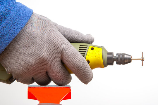 Engraving tool for cutting and processing metal and other objects in hand on a white background. locksmith industry