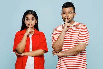 Young couple two friends family Indian man woman wear red casual clothes t-shirts together say hush...