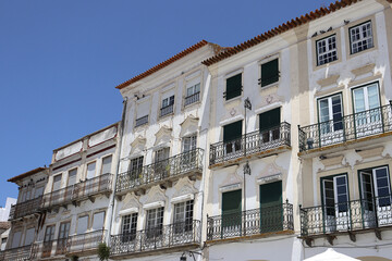 Fototapeta na wymiar Facades of typical buildings at the main square of the city: Praça do Giraldo, Évora, Alentejo, Portugal
