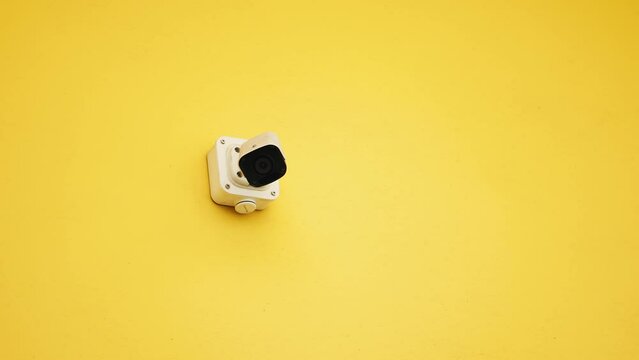 High-Rise Surveillance: BRIGHT yellow City Office Building with CCTV on Facade
