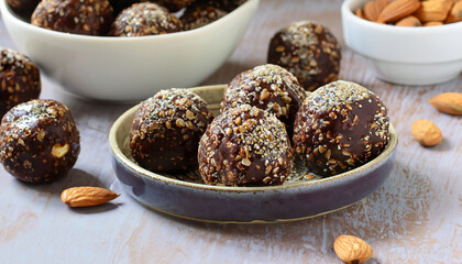 Healthy homemade paleo chocolate energy balls with rolled oats, nuts, dates and chia seeds, horizontal, copy space