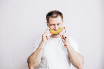 The guy is holding a banana in his hand. Men's health prostate prevention