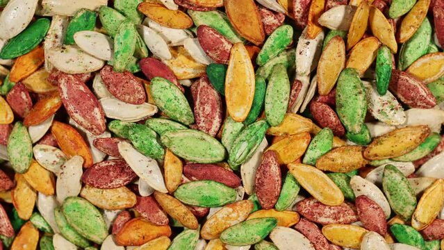 Red green white and orange roasted pumpkin seeds