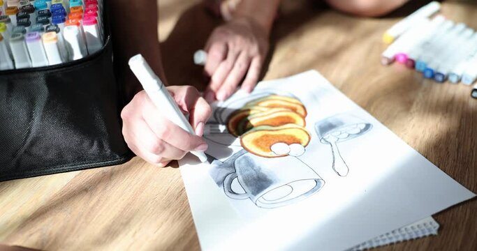 Artist hand drawing pancakes on piece of paper using markers closeup 4k movie slow motion. Hobby drawing concept