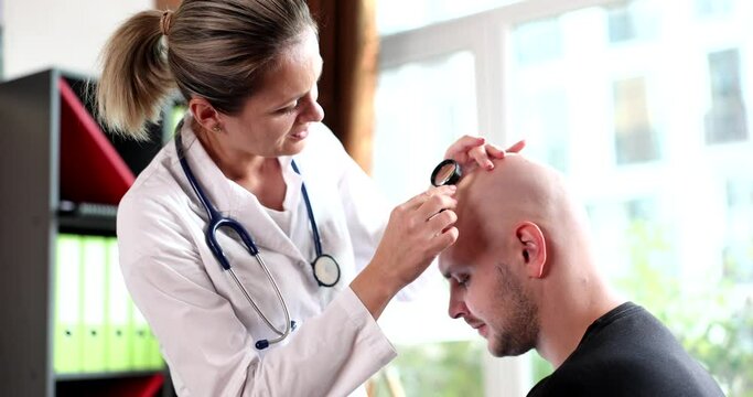 Doctor trichologist examining skin on head of bald man 4k movie slow motion. Male pattern baldness hormonal problems concept
