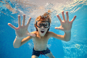 Excited boy showing palms in swimming pool © ADDICTIVE STOCK CORE