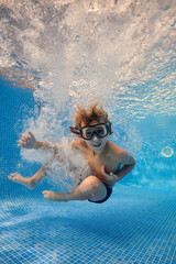 Boy jumping in bubbling water of pool