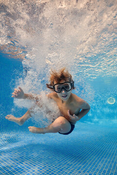 Boy jumping in bubbling water of pool