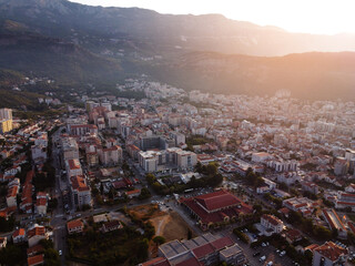 Aerial view of modern and old town cityscape of Budva, Mongenegro on Adriatic Sea coast and Saint Nikhola's island on background on summer sunny day. Center of tourism and popular sea resort.