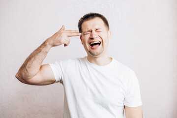 The guy holds his hands in the form of a pistol at his temple. Men's health prostate prevention