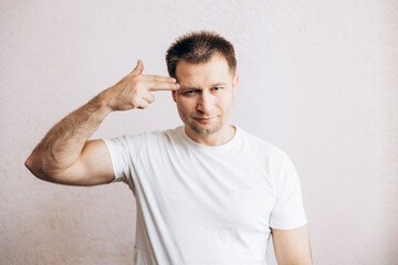 The guy holds his hands in the form of a pistol at his temple. Men's health prostate prevention