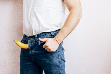 The guy is holding a banana in his jeans. Men's health prostate prevention