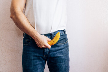 The guy is holding a banana in his jeans. Men's health prostate prevention