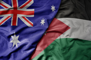 big waving realistic national colorful flag of australia and national flag of jordan .