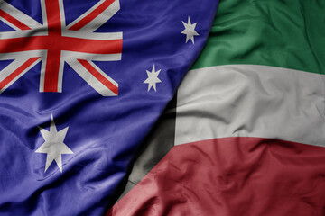big waving realistic national colorful flag of australia and national flag of kuwait .