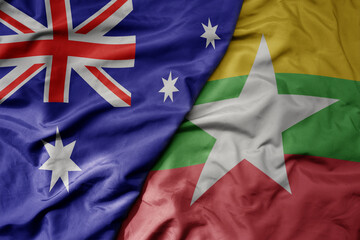 big waving realistic national colorful flag of australia and national flag of myanmar .