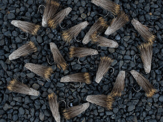 fishing flies on small rock