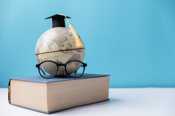 Graduation cap with Earth globe. Concept of global business study, abroad educational, Back to...