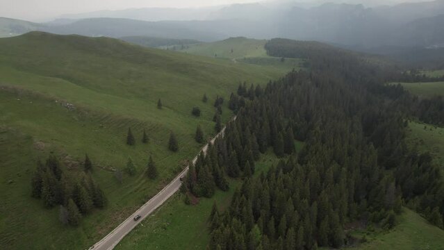 Aerial top view above Transbucegi winding road, in Transylvania	
