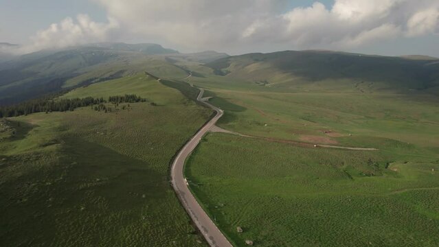 Aerial top view above Transbucegi winding road, in Transylvania	
