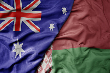 big waving realistic national colorful flag of australia and national flag of belarus .