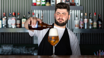 barmen pouring beer to a glass