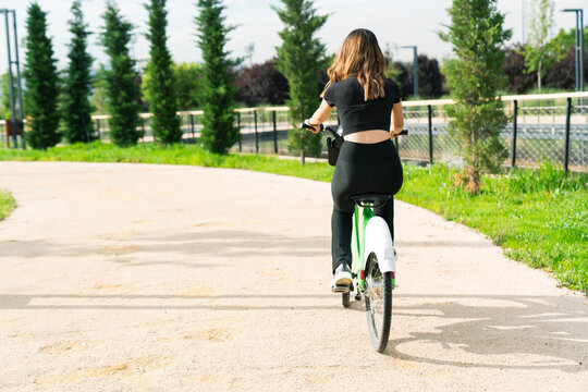 Woman riding bicycle at the park.