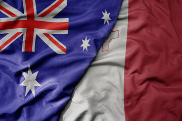 big waving realistic national colorful flag of australia and national flag of malta .