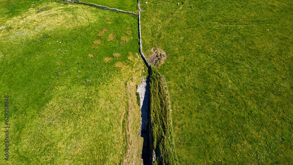 Sticker Aerial view of a rift in the coast at Streedagh Point. Connacht,