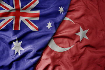 big waving realistic national colorful flag of australia and national flag of turkey .
