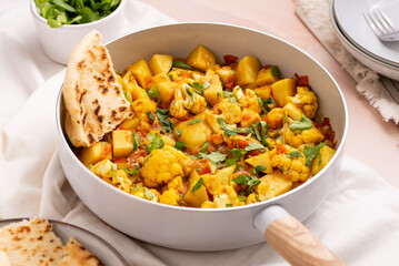 Delicious Aloo Gobi Masala stew: Authentic Indian Spicy Potato Cauliflower Curry with Exotic Spices and Nutritious Vegetables