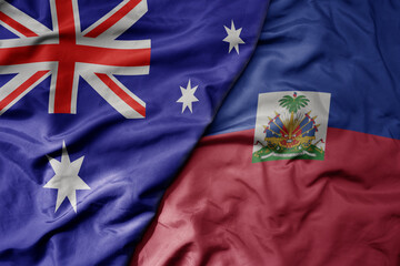 big waving realistic national colorful flag of australia and national flag of haiti .