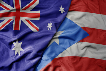 big waving realistic national colorful flag of australia and national flag of puerto rico .