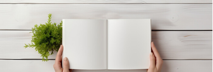 Hands holding an open book, a notebook with empty pages. Mockup for publications, citations. Flatlay