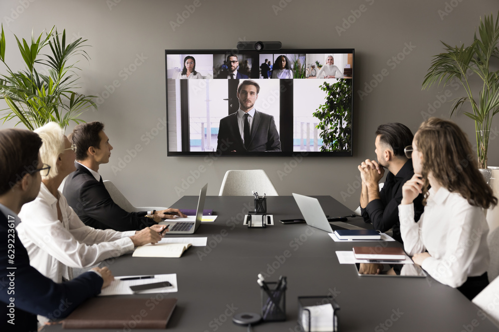 Poster Business team and leader meeting online and offline, sitting at conference table, looking at interactive board with headshots, listening to speaker, CEO, discussing project on group video call