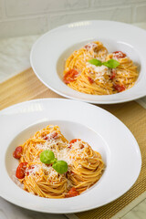 spaghetti with tomatoes, basil and parmesan cheese