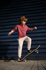 Little skater doing trick on street © ADDICTIVE STOCK CORE