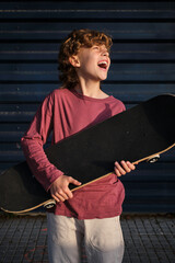 Excited boy with skateboard laughing © ADDICTIVE STOCK CORE