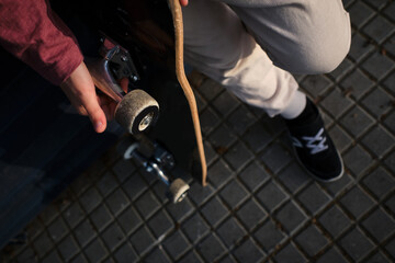 Crop skater resting on pavement © ADDICTIVE STOCK CORE