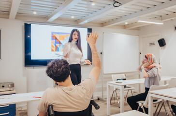 Businessman raising his hand at the seminar