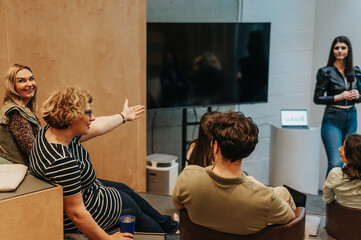 Middle-aged businesswoman gestures while explaining something during business training at work