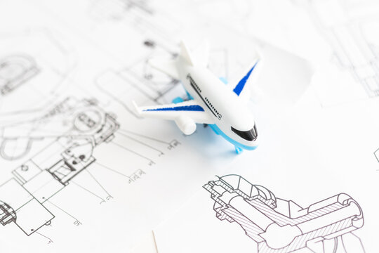 Image of passenger airplane and engineering blueprint
