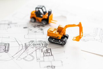 tractor toy on housing construction blueprint